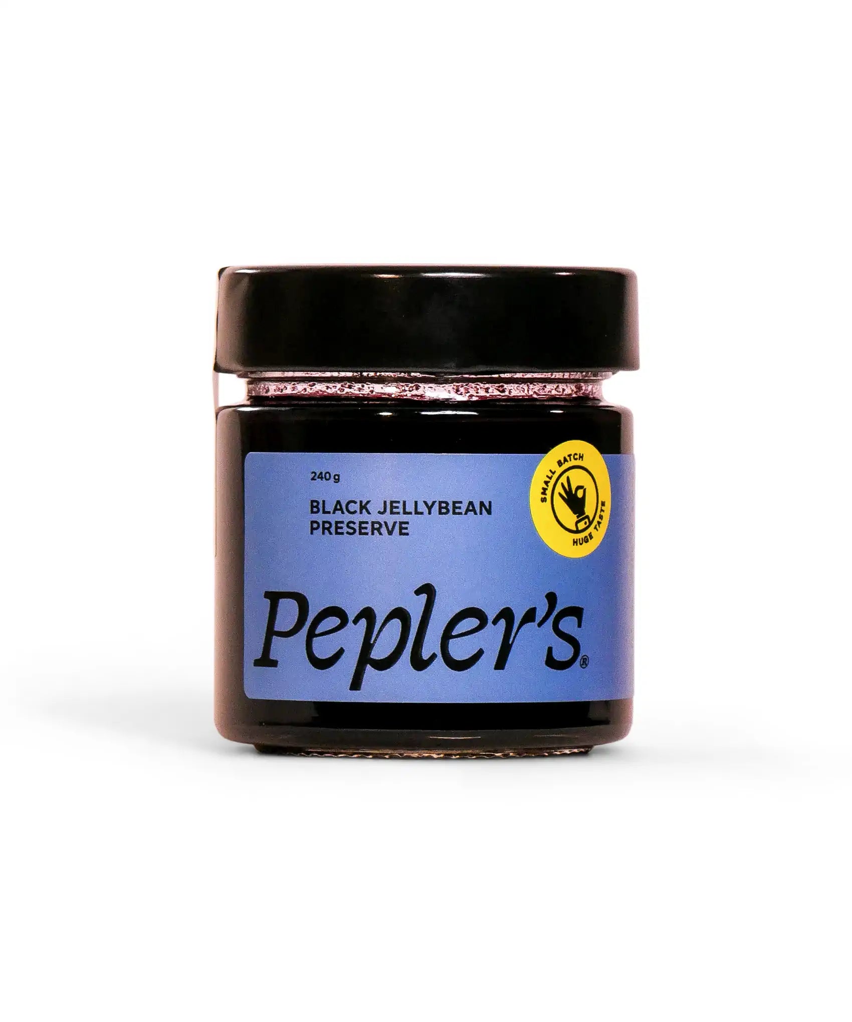 A glass jar of Pepler's black jellybean preserve, featuring a blue label with the product name and weight of 240 grams. The jar is topped with a black lid and displays a yellow emblem indicating it's made in small batches. The background is plain white, emphasising the jar's design.