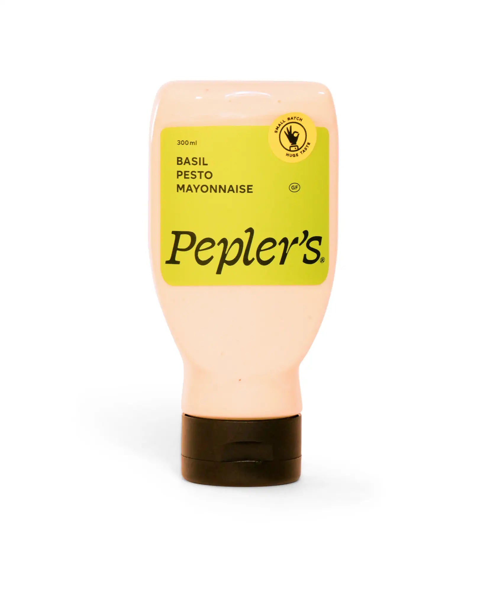 A squeeze bottle of Pepler's Basil Pesto Mayonnaise, featuring a vibrant green label prominently displaying the product name and a volume of 300 ml. The bottle has a black cap and a circular emblem stating "small batch huge taste," along with a gluten-free label. The background is a plain light colour, emphasising the product.