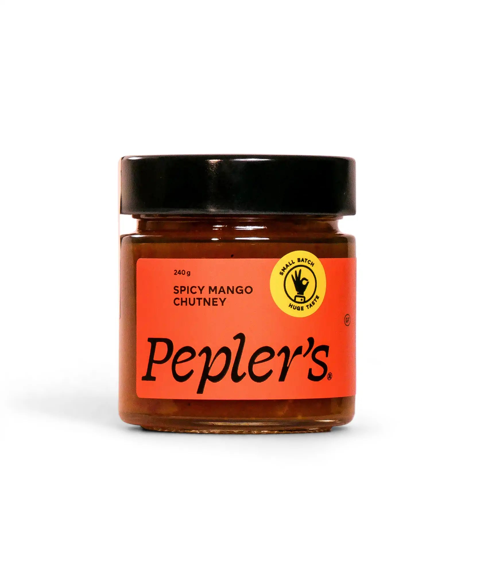 A jar of Pepler's Spicy Mango Chutney, weighing 240 grams. The jar features a vivid orange label with bold black text, clearly displaying the product name. A circular yellow emblem on the label highlights the phrase "Small Batch Huge Taste." The jar is set against a plain white background.