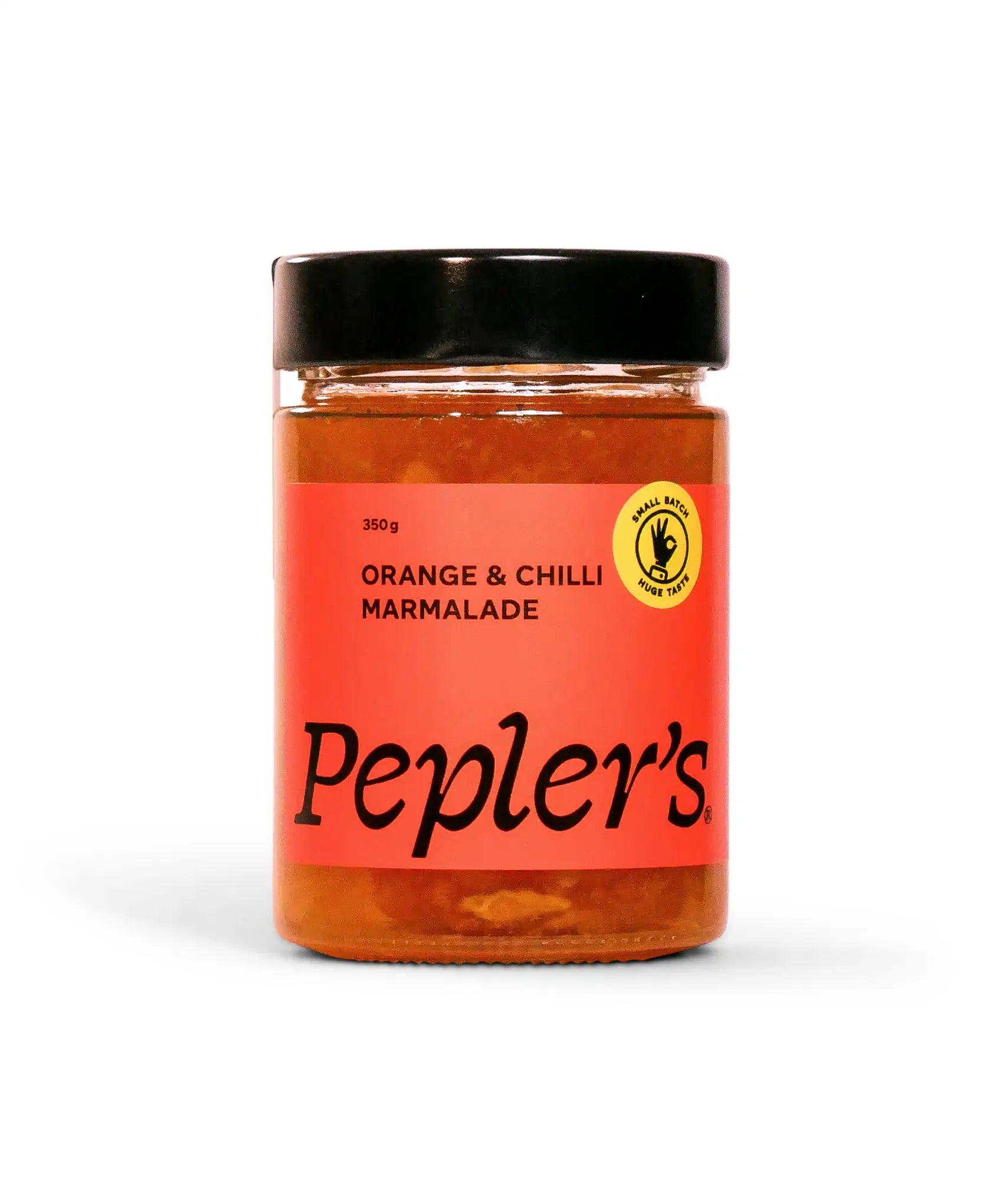 A jar of Pepler's Orange & Chilli Marmalade, containing 350 grams, is prominently displayed against a white background. The jar features a vibrant label with a bold orange background, showcasing the product name in an elegant black font. There is also a circular yellow badge indicating "Small Batch Huge Taste." The jar is sealed with a black lid.