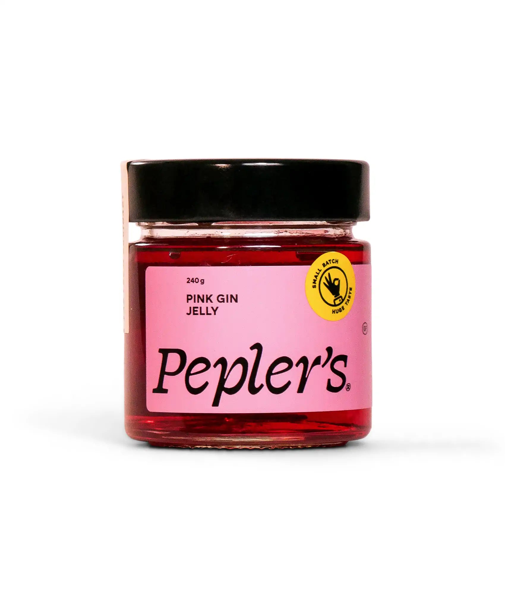 A jar of Pepler's Pink Gin Jelly, weighing 240 grams, featuring a vibrant pink colour. The jar has a black lid and a label with the product name prominently displayed in bold lettering. A yellow circular logo indicates that it is a small batch product. The background is plain white, emphasising the jar and its design.