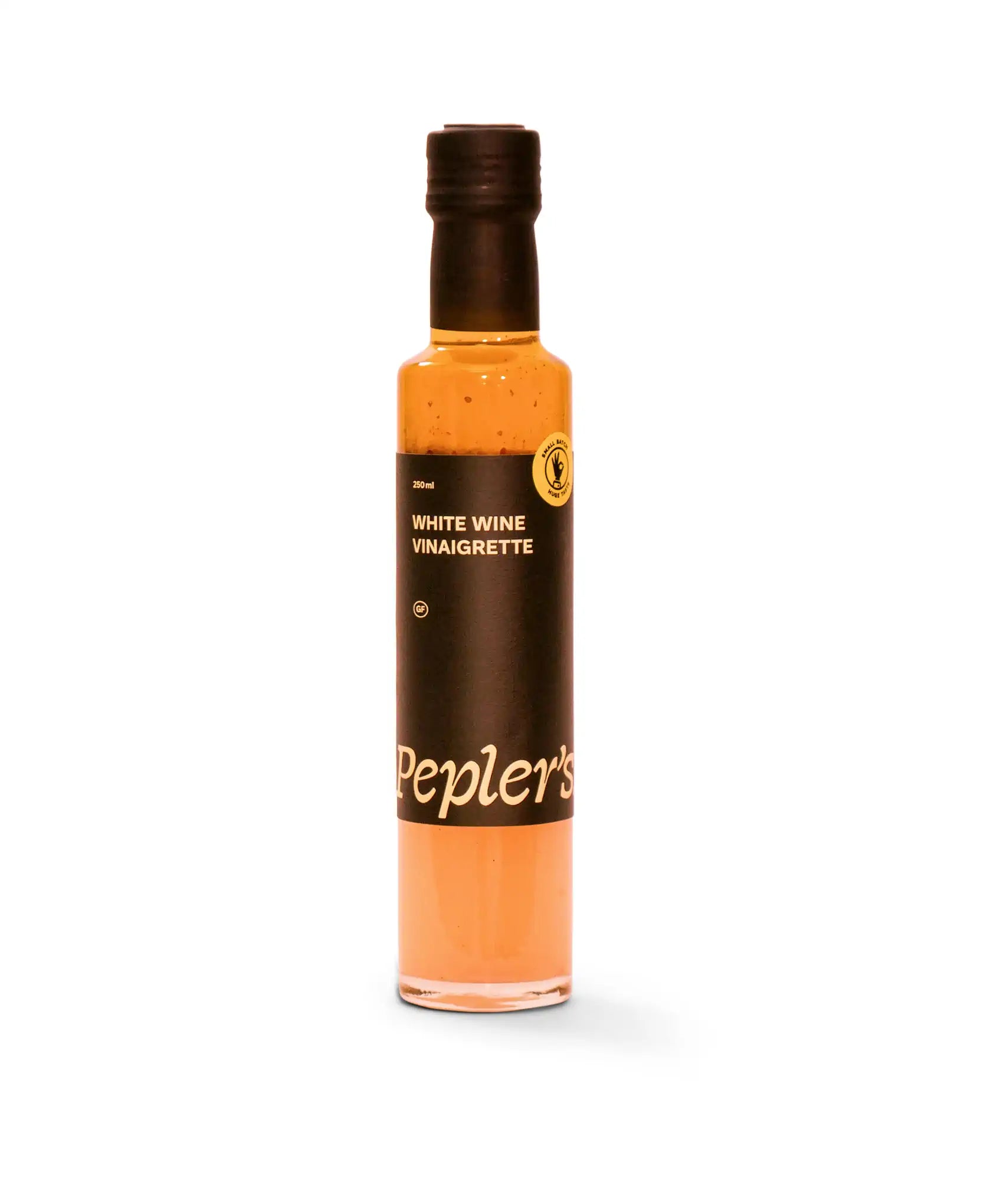 A bottle of Pepler's white wine vinaigrette on a white background. The glass bottle holds 250 ml of a light brown, creamy vinaigrette. The label is predominantly black with white text stating "WHITE WINE VINAIGRETTE" and includes a gluten-free (GF) symbol, along with the brand name "Pepler's" in a stylish font. The bottle has a black cap.